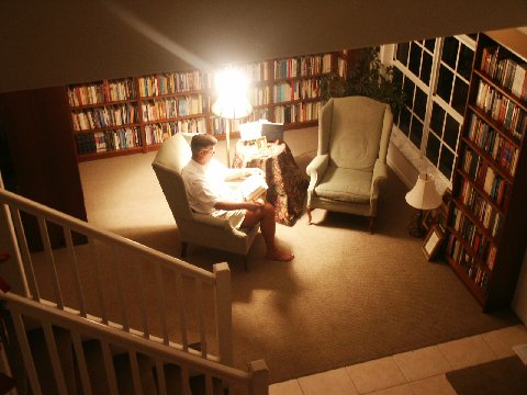 Dr. Beisner reading in his home library where he and his wife Debby have approx. 16,000 volumes.